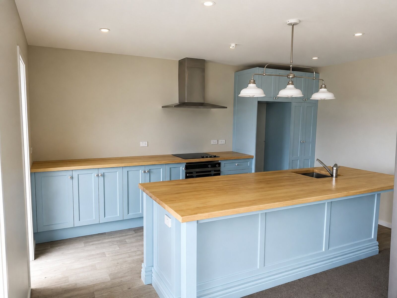 Duck egg blue cabinetry hand painted with a timber benchtop