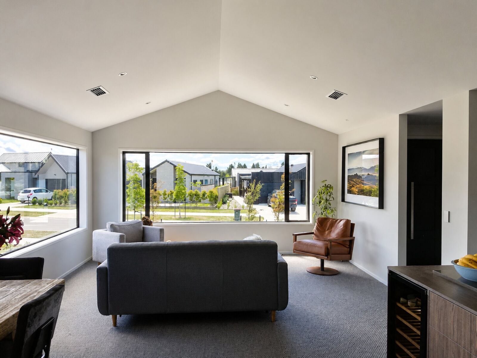 Repainted lounge with a vaulted ceiling and full height windows