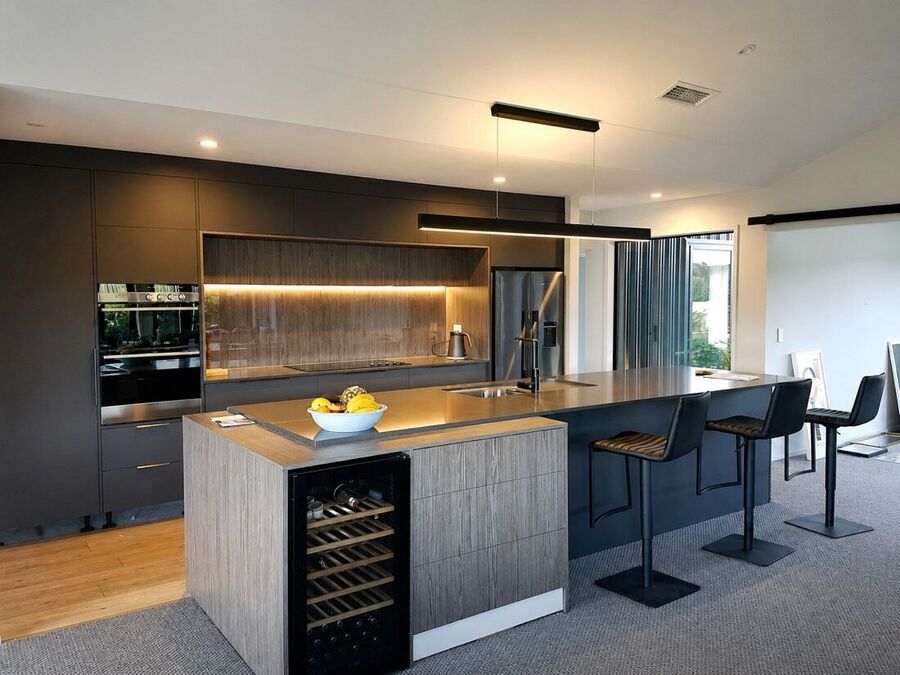 Modern dark kitchen in charcoal with timber features and a finished living space